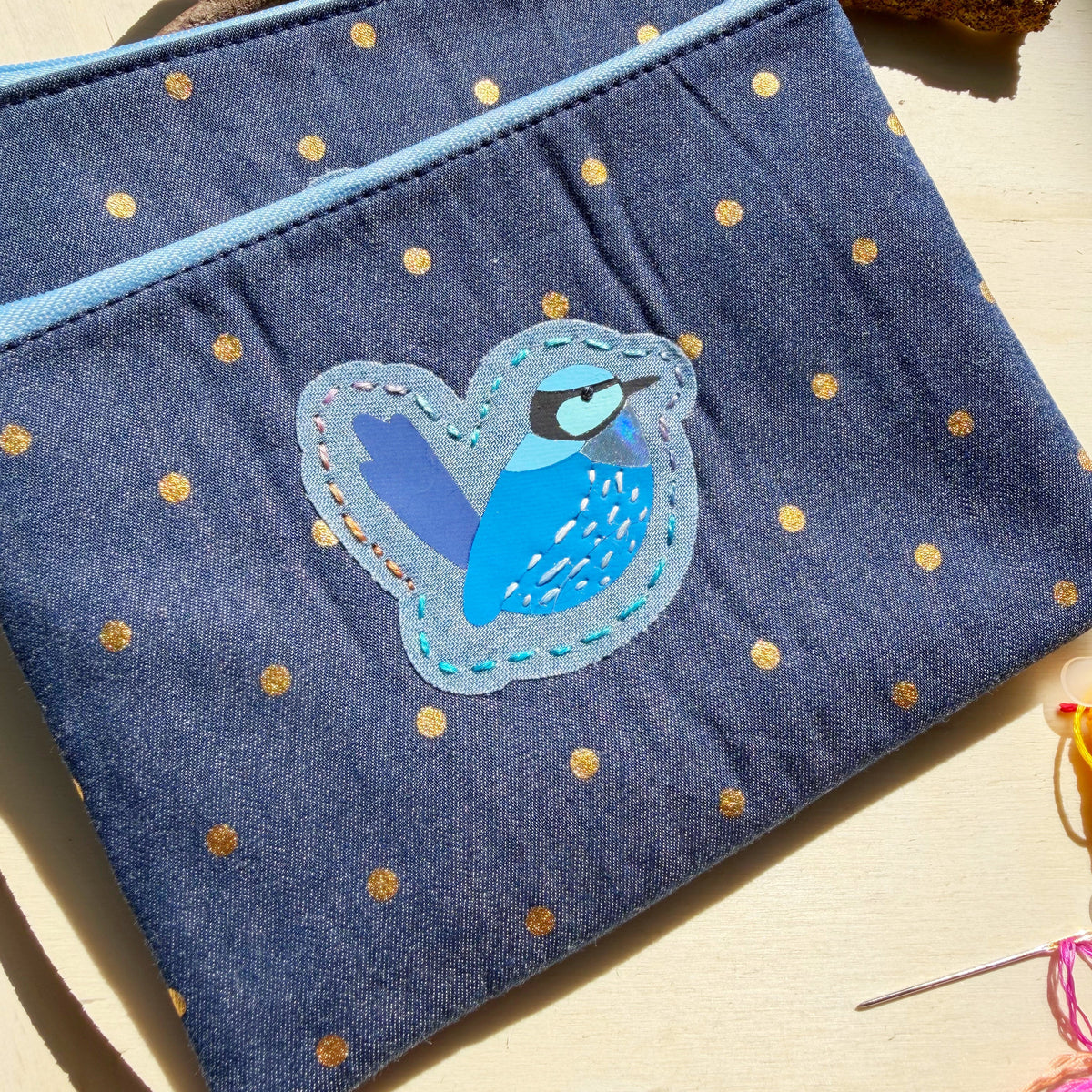 handmade blue denim with gold polkadots zip pouch featuring bright blue splendid fairy wren bird with embroidered detail