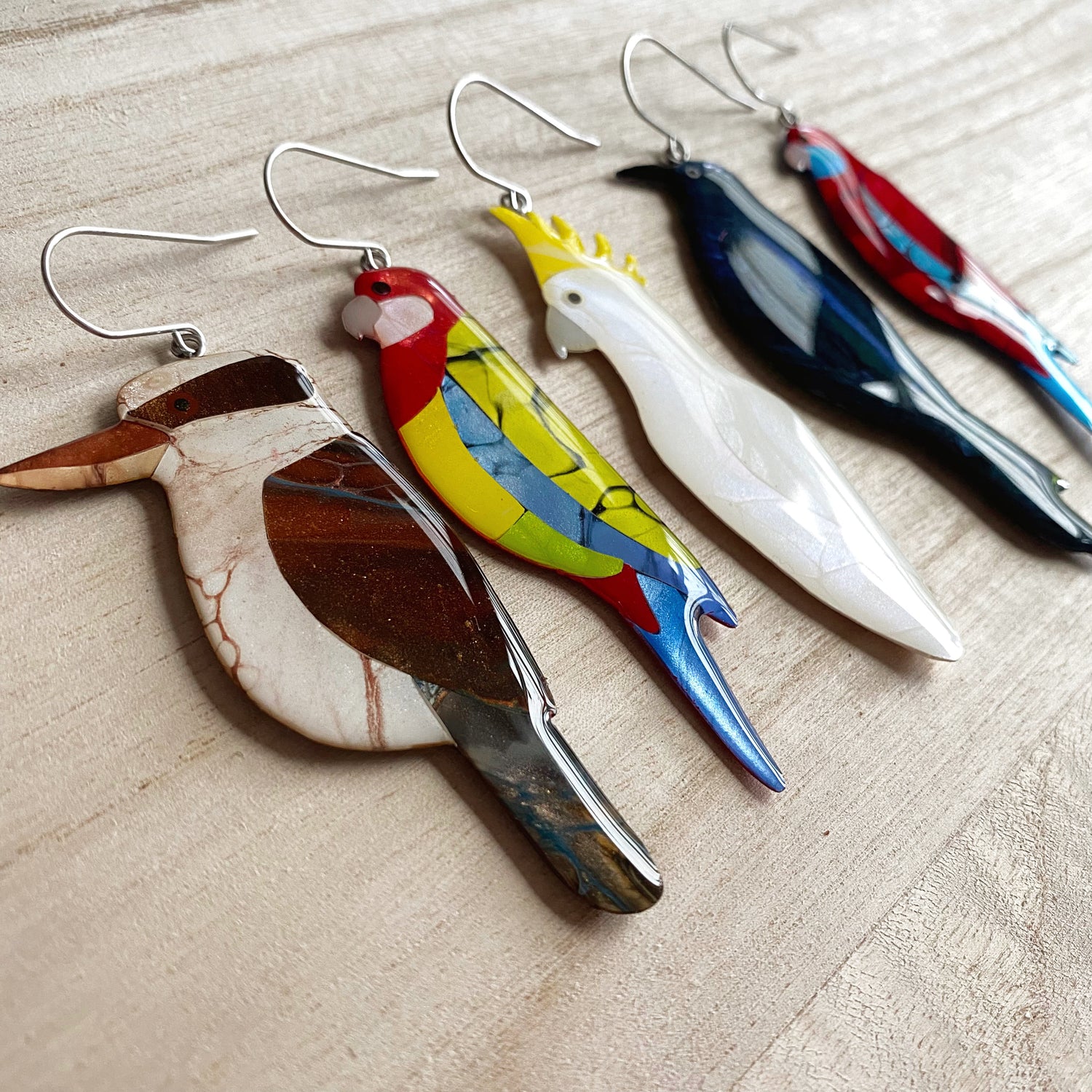 group of various australian bird earrings made with resin and acrylic paint