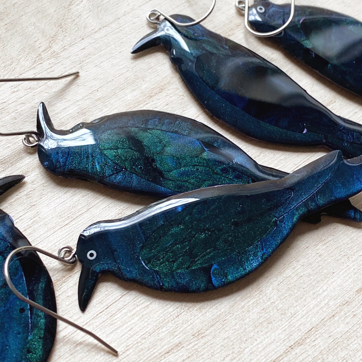 group of handmade Australian Raven earrings, with a blue/black shimmer