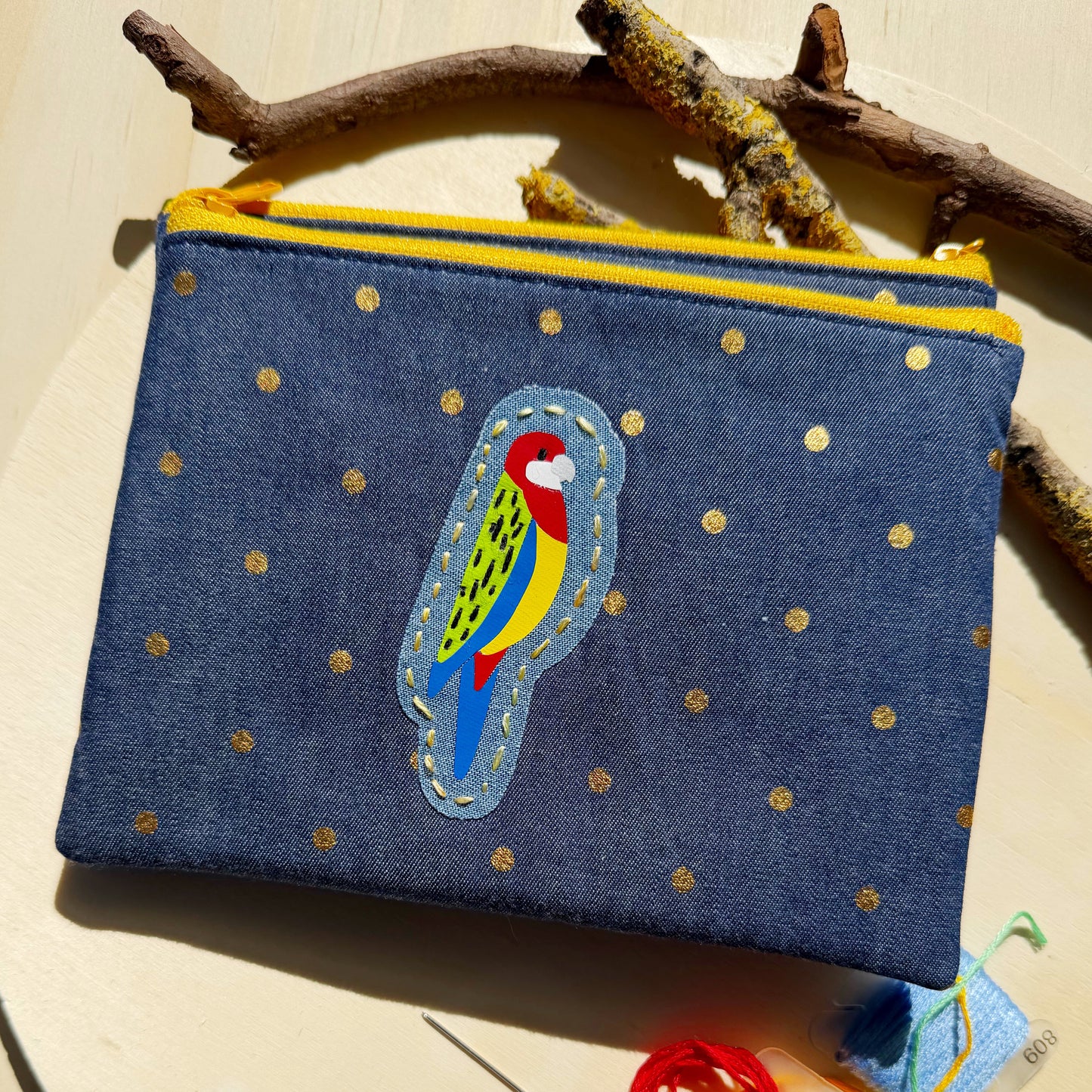 handmade zip pouch featuring eastern rosella bird design with handstitched details