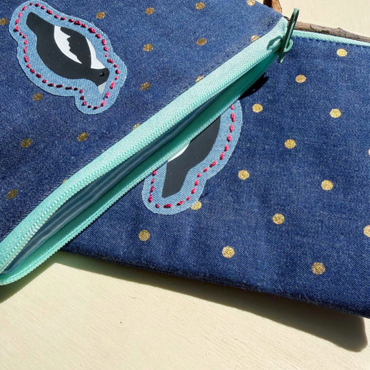 handmade zip pouch with Australian Magpie design with a closeup of the interior lining