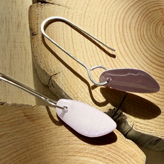 lavender coloured organic teardrop earrings on wooden surface