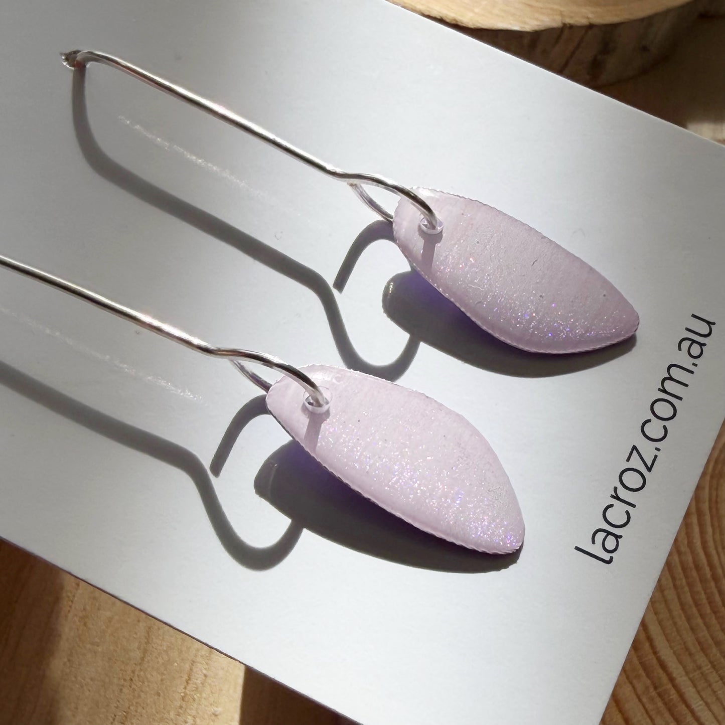 lavender coloured organic teardrop earrings on business card