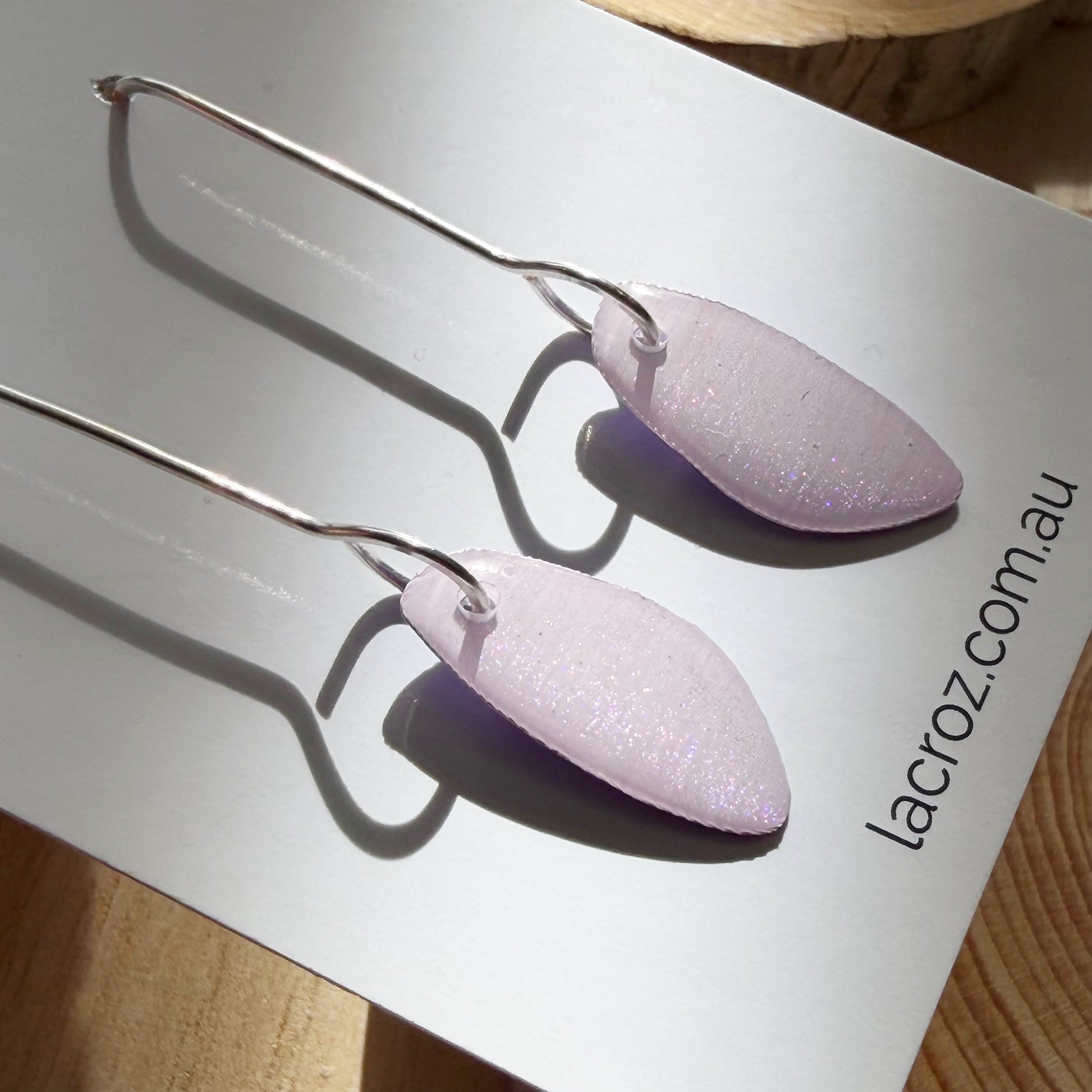 lavender coloured organic teardrop earrings on business card